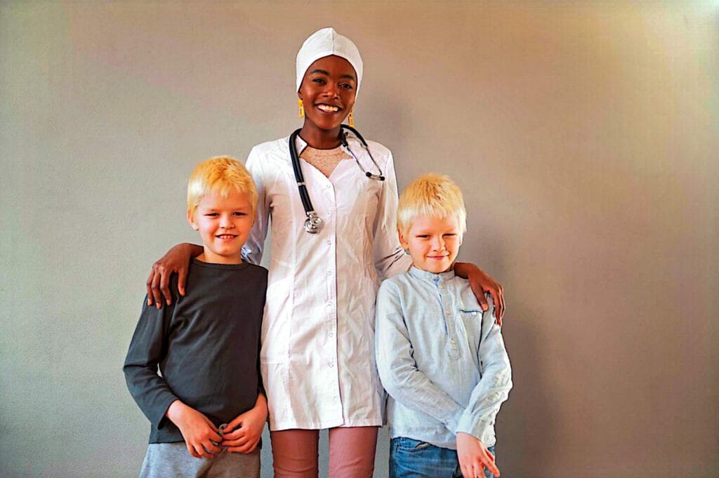 Caregiver spending time with two children at home