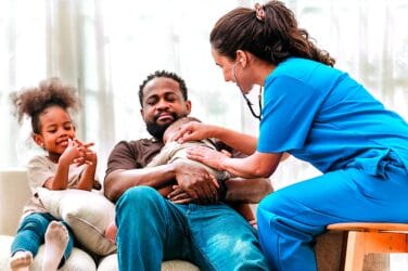 Nurse providing home care support to a family with children