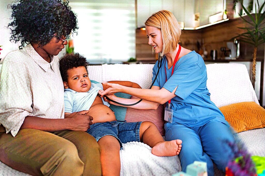 Healthcare professional supporting a mother and baby at home